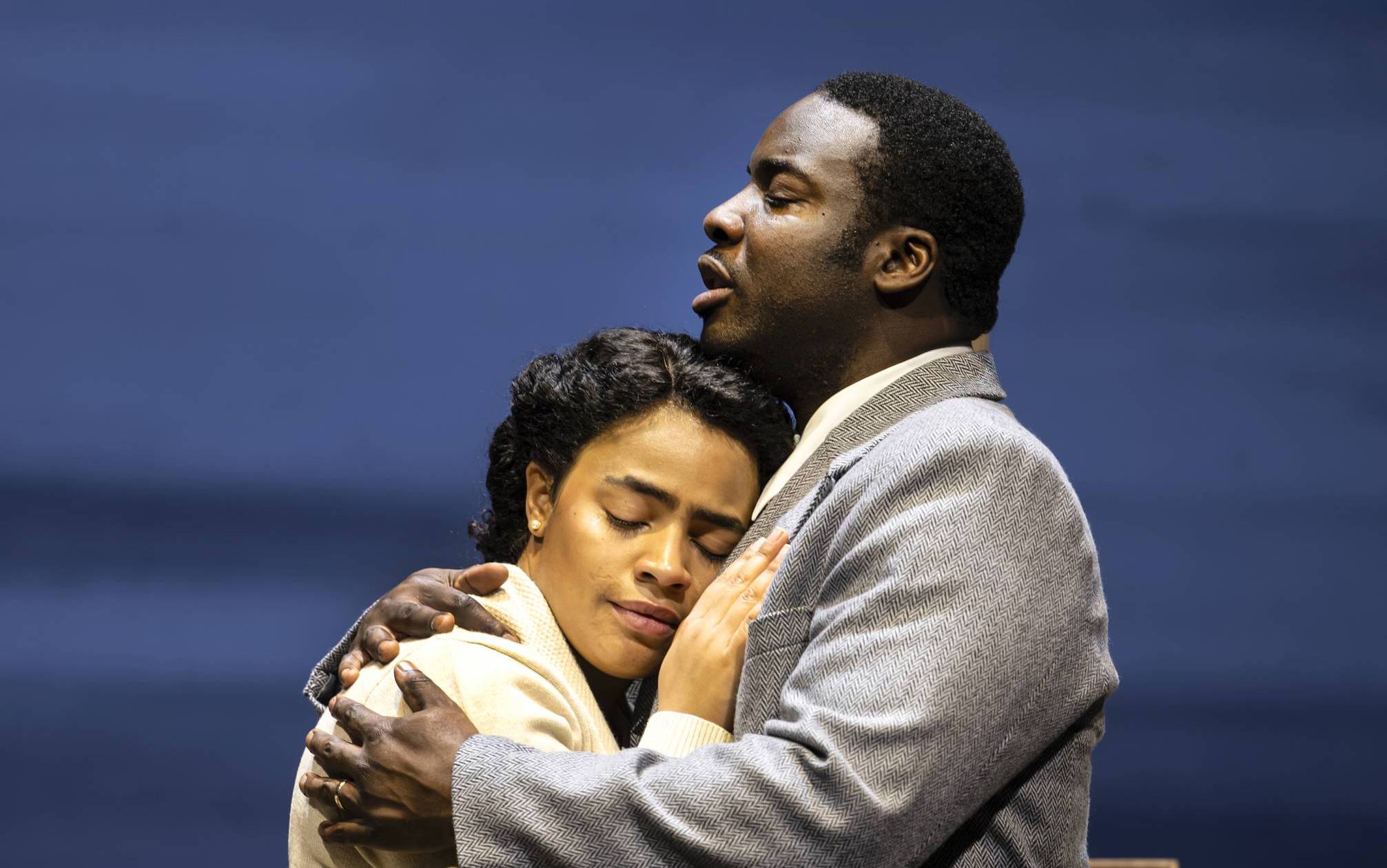 A man and woman embrace each other.