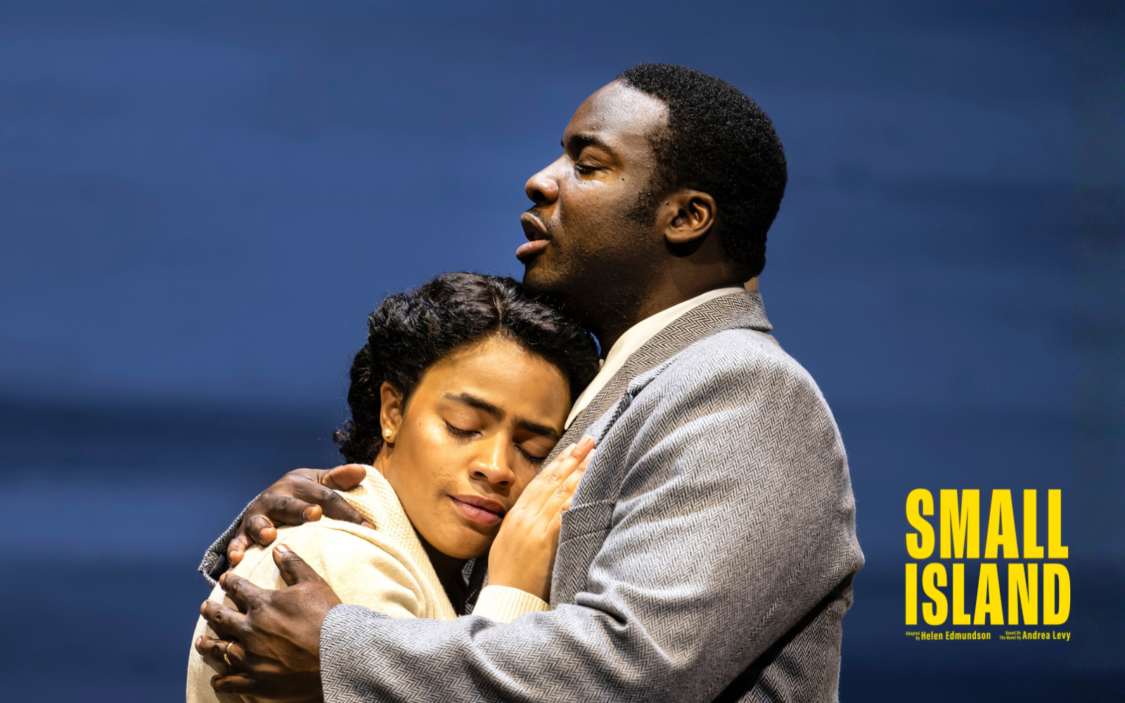 A man and woman embrace tenderly against a blue background. Text reads 