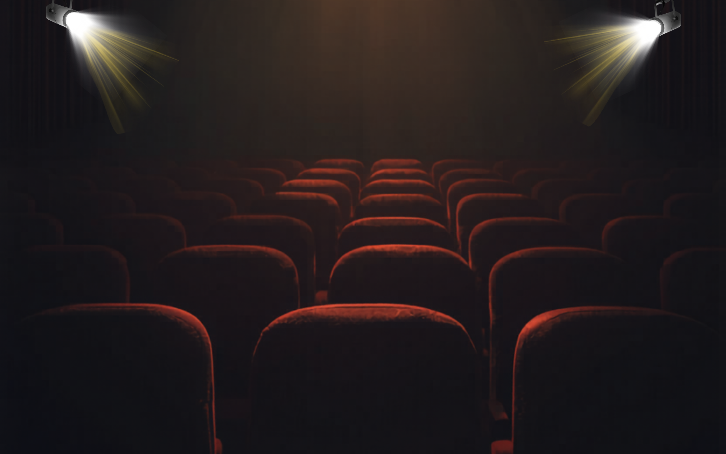 A dark image of red cinema chairs with two spotlights.
